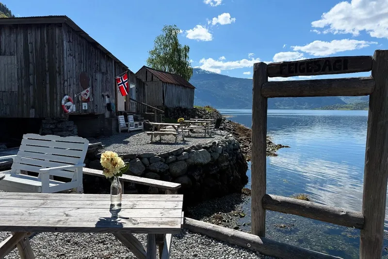 The old sawmill buildings at Feigum by Lustrafjorden, benches on the gravel outside